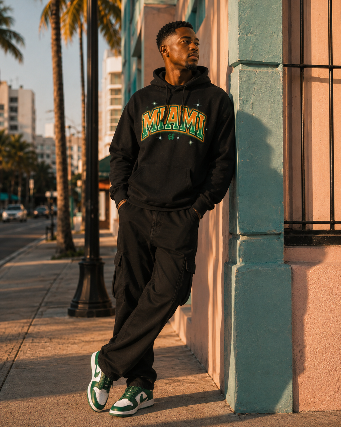 Model wearing the Miami Airbrush Fleece Hoodie in black with orange and green Miami artwork, front lifestyle view
